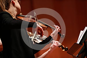 Classical music. Violinists in concert. Stringed, violinist. Closeup of musician playing the violin during a symphony