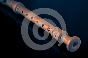 Classical musical instrument is the block flute on black background