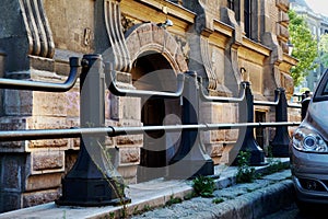 Classical old Europen stone and stucco building facade detail with cast iron railing photo