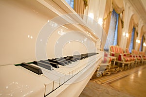 Classical Piano - white and black keys. Golden luxury ballroom