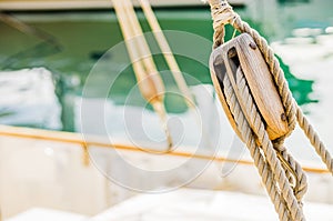 Classical sailing yacht deck, rigging wooden pulley and nautical ropes