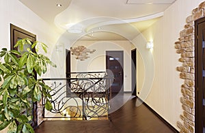 Classical stairs with ornamental handrail in hallway with doors