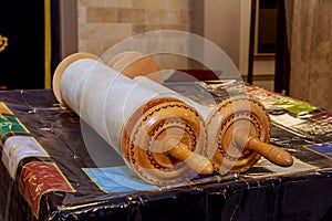 Classical Torah scrolls in a blue case with Hebrew letters. Torah