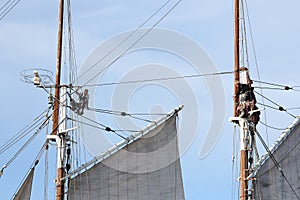 Classical, traditional wooden yacht and sailors on the mast sailing for Bodrum Cup.