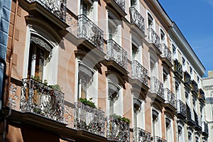 Classical vintage building facade with small elegant balconies in Chueca district dowtown Madrid