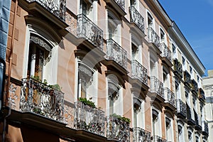 Classical vintage building facades with elegant metallic balconies in Chueca district dowtown Madrid, Spain photo