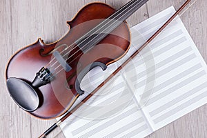 Classical violin with empty music sheet book. Studio shot of old violin