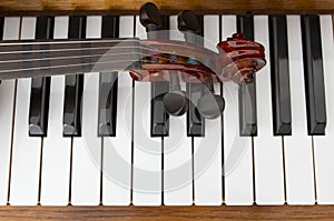 Classical violin on wooden piano keys. Classical violin on piano for music background concept. Holiday concert. Music concept