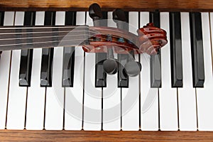 Classical violin on wooden piano keys. Classical violin on piano for music background concept. Holiday concert. Music concept