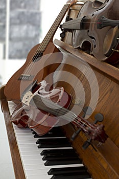 Classical violins on piano keys, guitar and cymbal. Classical musical instruments for music background concept