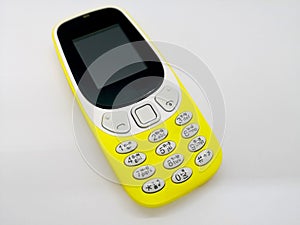 Classical yellow mobile phone. Communication concept. o