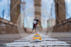 Classical yellow taxi model on an empty Brooklyn Bridge during lockdown in New York, because of the pandemic