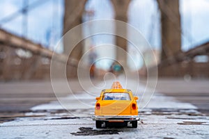 Classical yellow taxi model on an empty Brooklyn Bridge during lockdown in New York, because of the pandemic