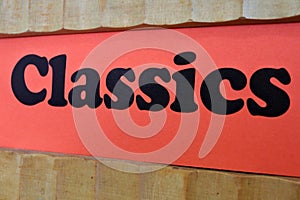 Classics Red Sign Background on a book shelf