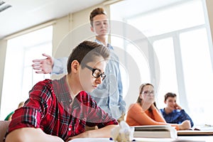 Classmate offending student boy at school