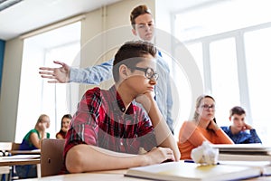 Classmate offending student boy at school photo