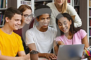 Classmates checking on exam results online, using laptop