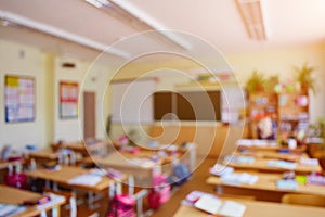 Classroom in a blurred background with no children. Students left their backpacks and notebooks and went on a break