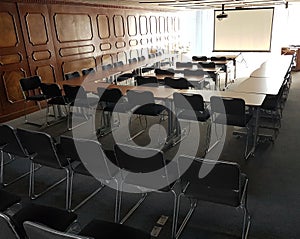 Classroom with chairs black color and slide projector