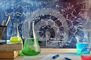 Classroom desk and drawn blackboard of chemistry teaching genera