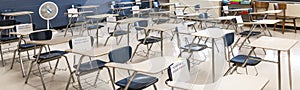 Classroom desks separated six feet apart by row and marked not available