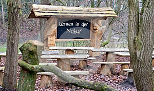 A classroom in the forest. The German text \