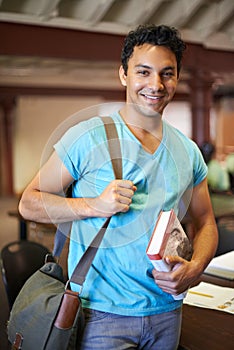 Classroom, man or college student with book, portrait or studying for knowledge, development or academy. Person, bag and