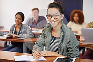 Classroom, student and portrait with smile in university for answer, information and education. College, girl and