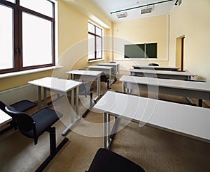 Classroom with wooden school desks and chairs