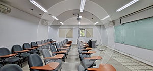 Classrooms for students in campus buildings with chairs and glass boards.