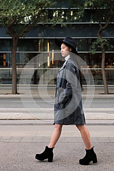 Classy asian woman walking in the city with hat