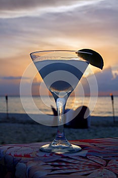 Classy cocktail at the Beach with a Purple, Pink and Gold Sunset. Vertical Image. photo