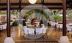 Classy elegant and modern restaurant at beach resort in Bali Indonesia. Seats, tables and lamps at luxury premium hotel.