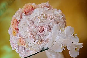 Classy floral arrangement in a pastel round bouquet featuring pink hydrangea roses and orchids