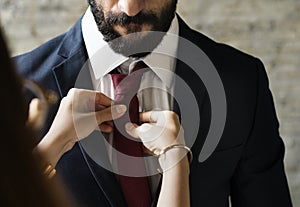 Classy man being dressed up by his wife