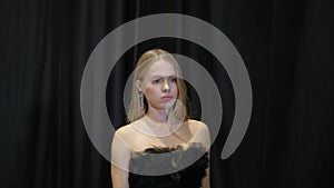 Classy model girl in transparent dress walks on defile podium. Fashion catwalk. photo