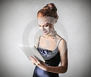 Classy woman using a tablet