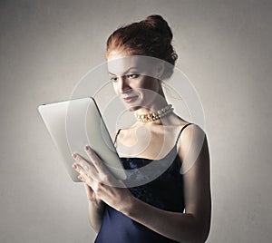 Classy woman using a tablet