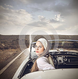 Classy woman in a vintage car