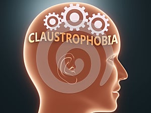 Claustrophobia inside human mind - pictured as word Claustrophobia inside a head with cogwheels to symbolize that Claustrophobia