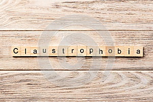 Claustrophobia word written on wood block. claustrophobia text on table, concept