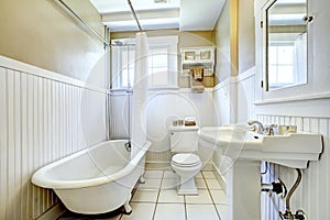 Claw foot tub in white bathroom
