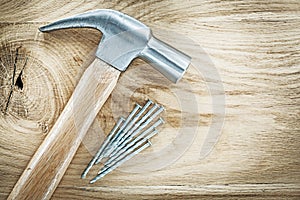 Claw hammer nails on wooden board building concept