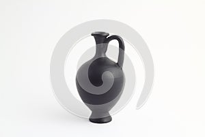 Clay black jug isolated on a white background.