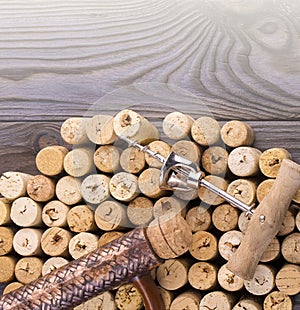 Clay bottle, metal corkscrew and cork on a wooden table