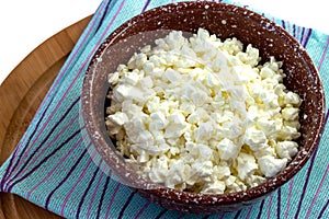 In a clay bowl, healthy fresh cottage cheese for dietary nutrition and health.