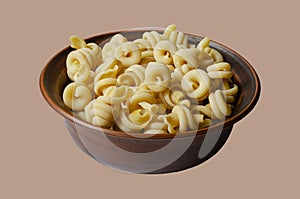 Clay bowl full of uncooked insalatonde pasta