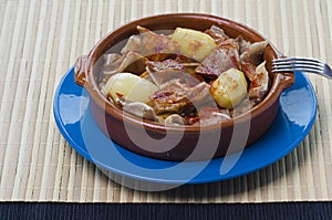 Clay bowl with pig`s ear cooked.