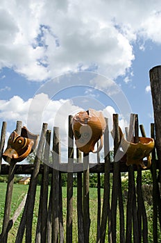 Clay broken pitchers hang wooden rural woven fence