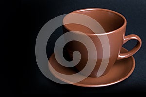 Clay (ceramic) cup on dark